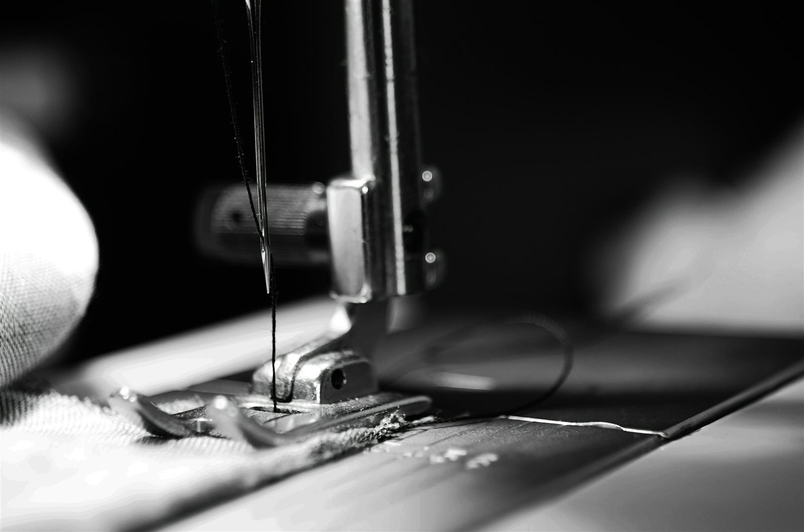 Garment worker sewing fabric on a sewing machine